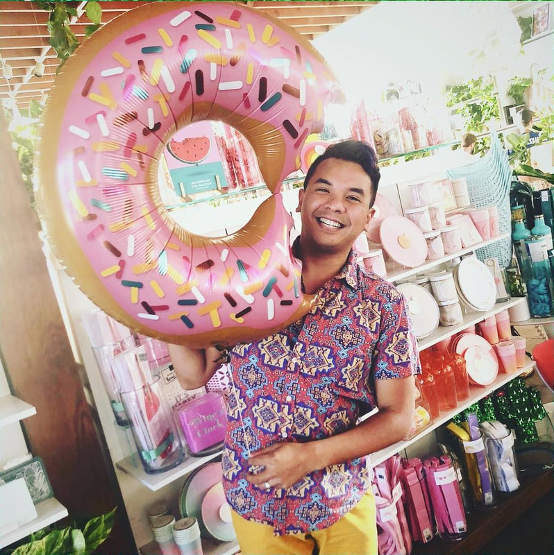 Shaun poses with a DONUT balloon